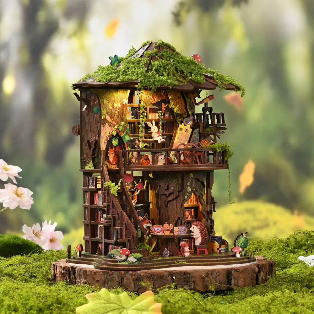 A detailed wooden forest tea book club treehouse miniature with moss roof and tiny animal figurines with led lighting