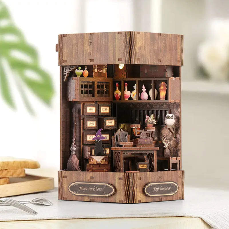 Magic book house diorama kit with witch figurine and potion shelves