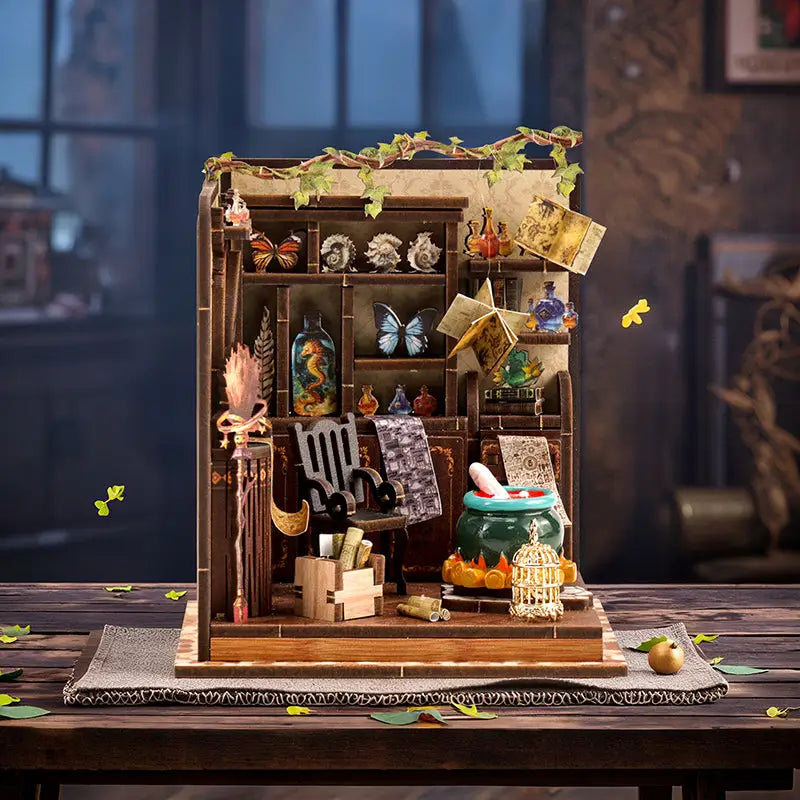 Magic potion workshop book nook kit with wooden diorama shelves of bottles, butterflies, and green cauldron