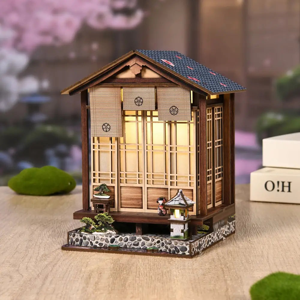 Miniature wooden japanese-style moss lantern harmony with dark blue roof and warm led light perfect for australia gardens