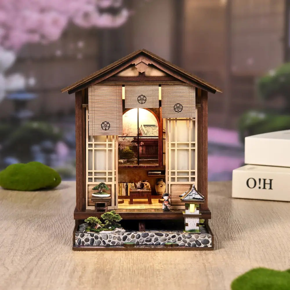 A miniature wooden japanese-style moss lantern harmony house with led light and dark roof from australia