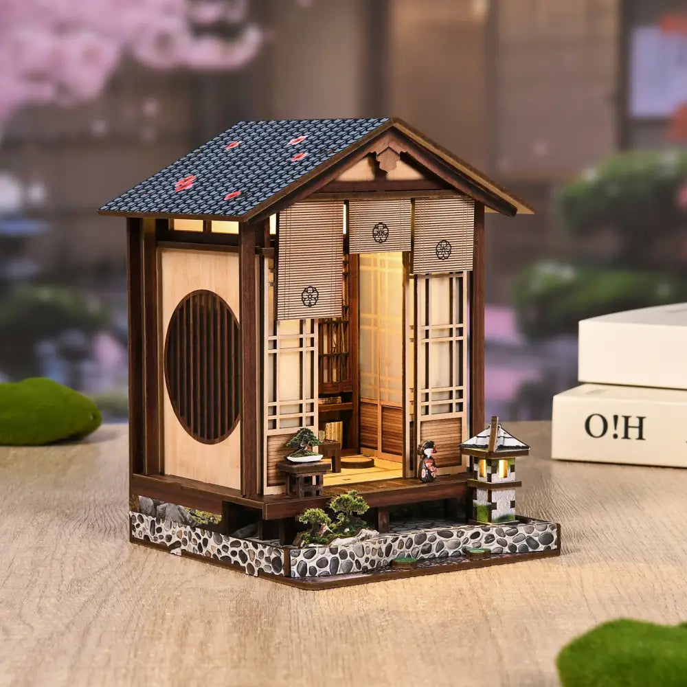 A miniature japanese-style wooden moss-lantern harmony house with blue tiled roof and led light in australia