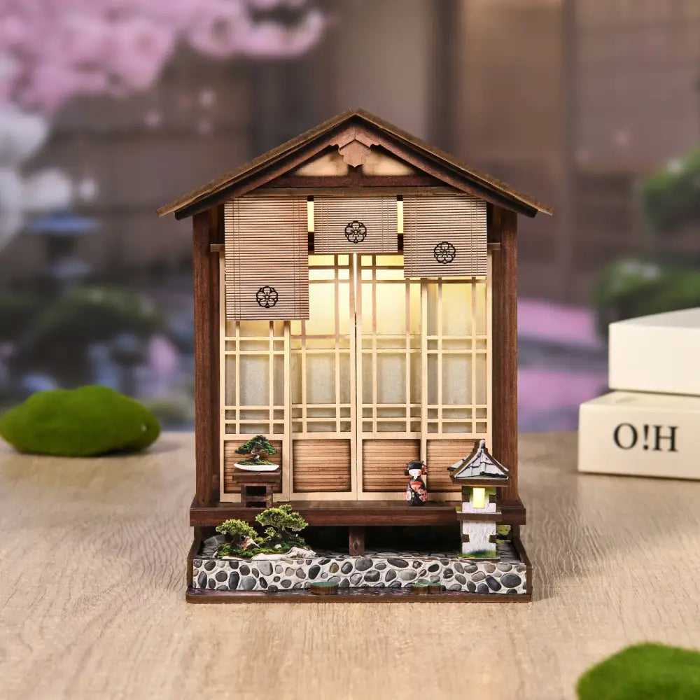 A miniature wooden japanese-style moss-lantern harmony with led light and bamboo slat windows from australia