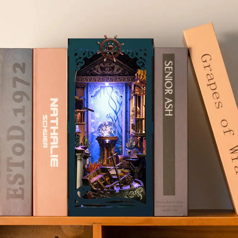 Teal illuminated deep sea mystery book nook with nautical underwater diorama