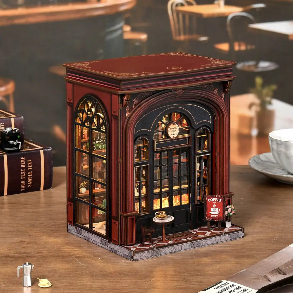 A miniature red and black warmglow coffee diy book nook with arched windows and detailed interior lighting