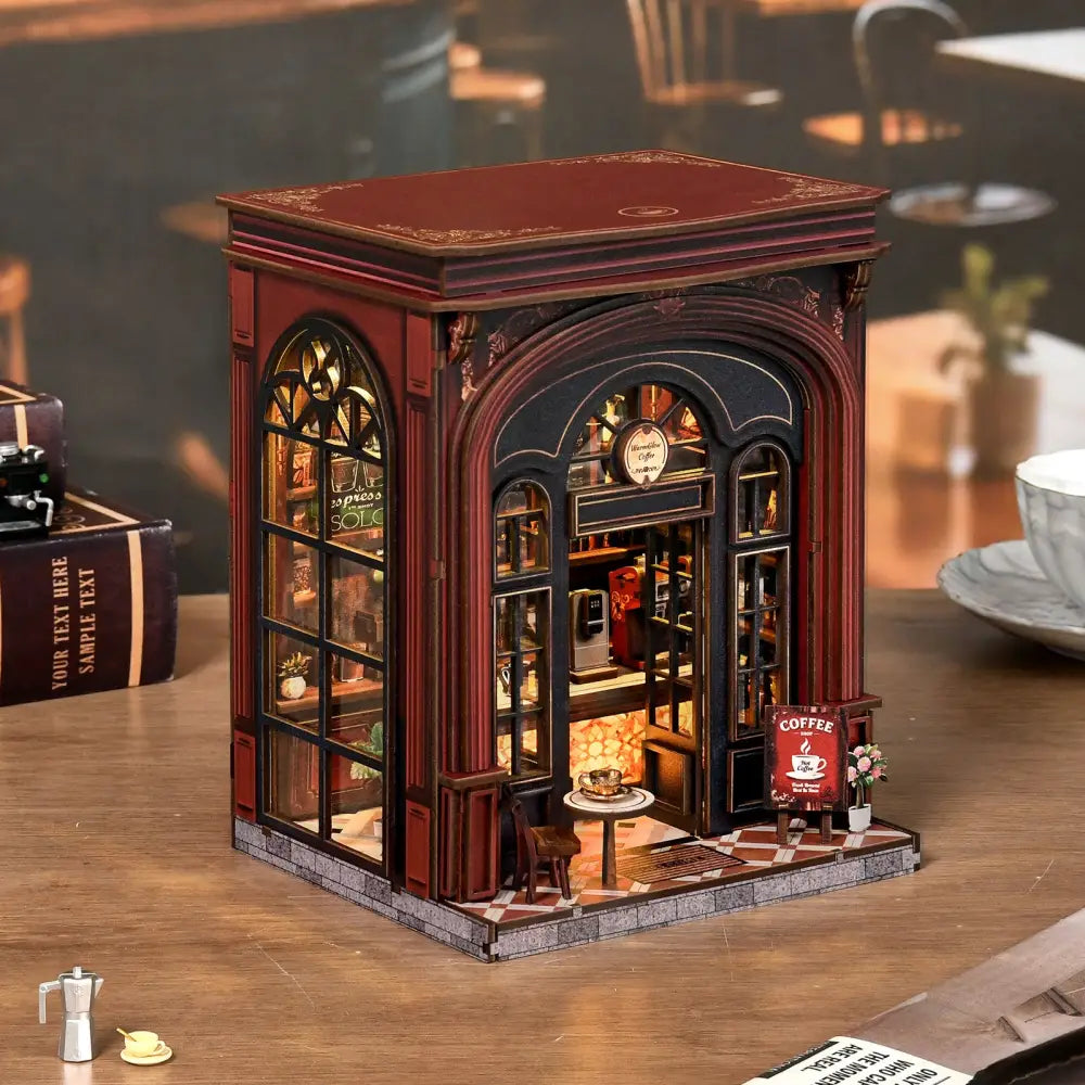 A warmglow coffee diy book nook featuring a detailed red and black miniature coffee shop with arched windows and shelves